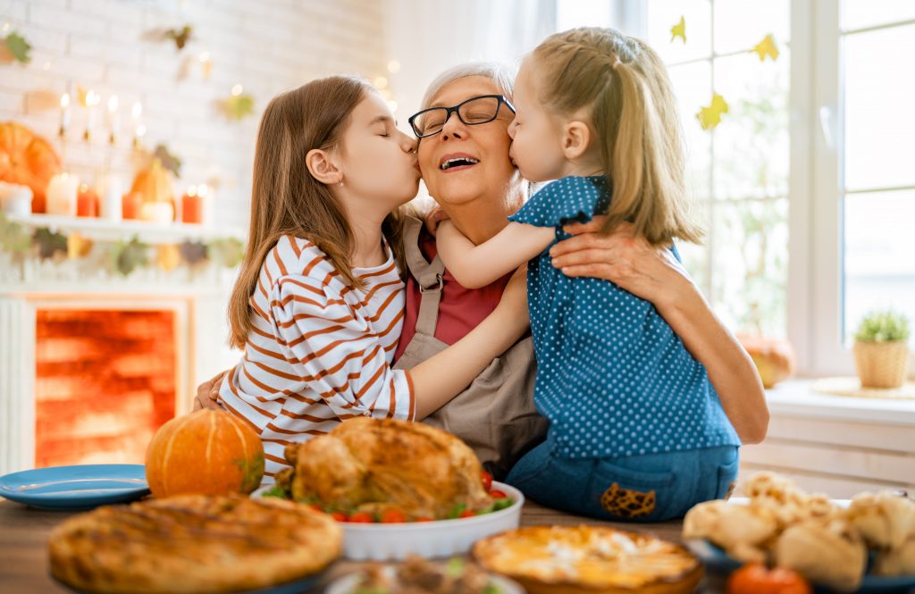 Two girls visit with grandma for Thanksgiving dinner. 