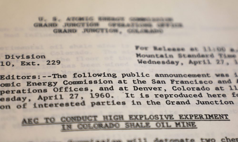 A public announcement letter from the U.S. Atomic Energy Commission from 1960. It informs local governments of an explosive experiment taking place in a Colorado shale oil mine.