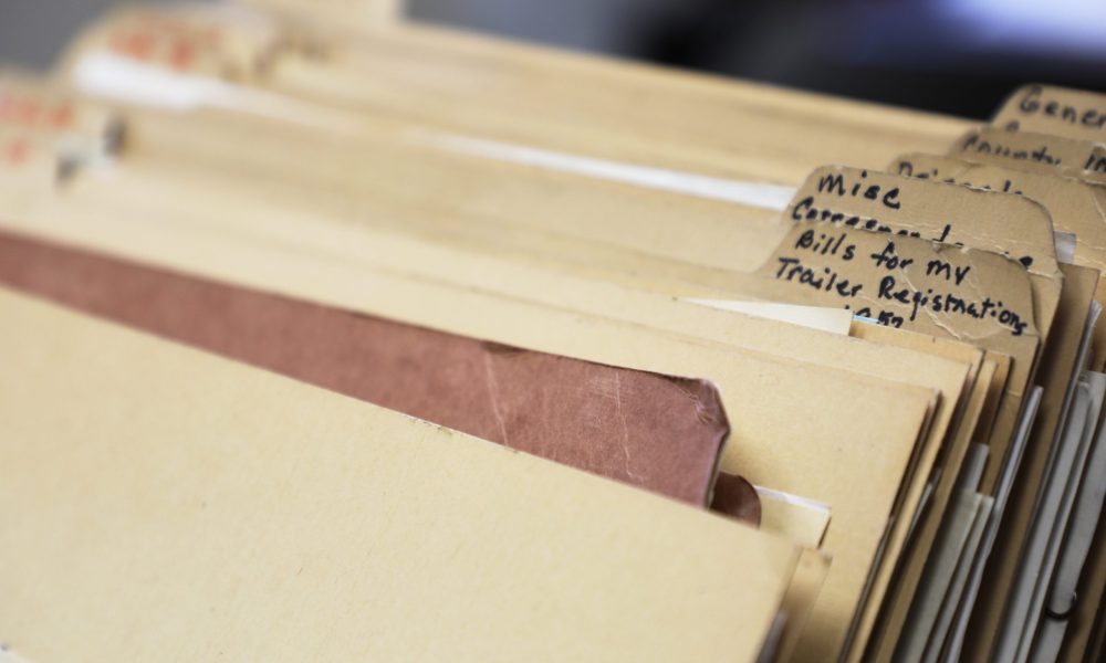 A stack of folders filled with correspondence letters from 1923 to 1976 at the Garfield County Clerk and Recorder's Office in Glenwood Springs, CO.