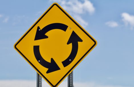 A horizontal format shows a roundabout sign to the left.