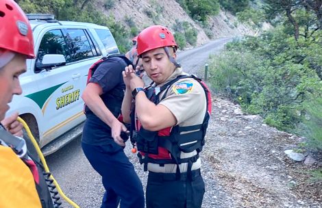 Deputy Vargas of the Garfield County Sheriff's Office assists Garfield County Search and Rescue with a rescue operation on the Roaring Fork River near Glenwood Springs, CO.