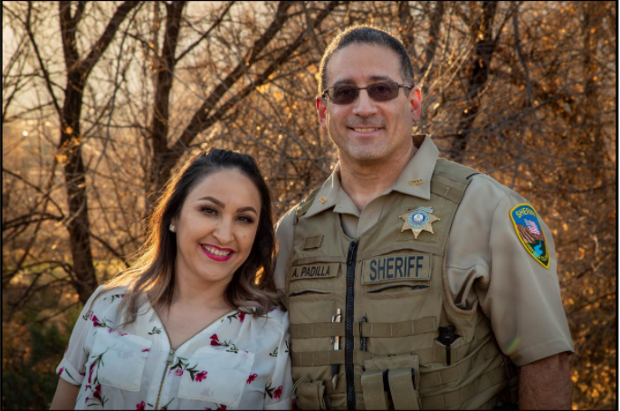 Garfield County Sheriff's Office Deputy A. Padilla stands with a smiling woman. 